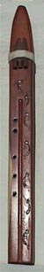 His first aromatic cedar Apache double flute with 10 strands of 8-inch leather fringe and reversible black walnut bird